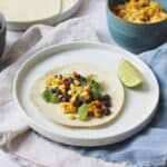 Vegan Corn and Black Bean Tacos served with lime wedges