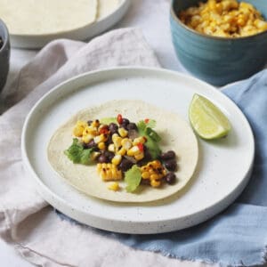 Vegan Corn and Black Bean Tacos served with lime wedges