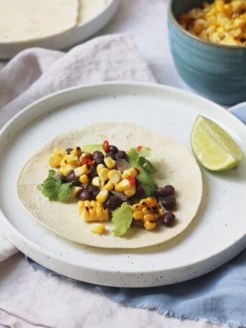 Vegan Corn and Black Bean Tacos served with lime wedges