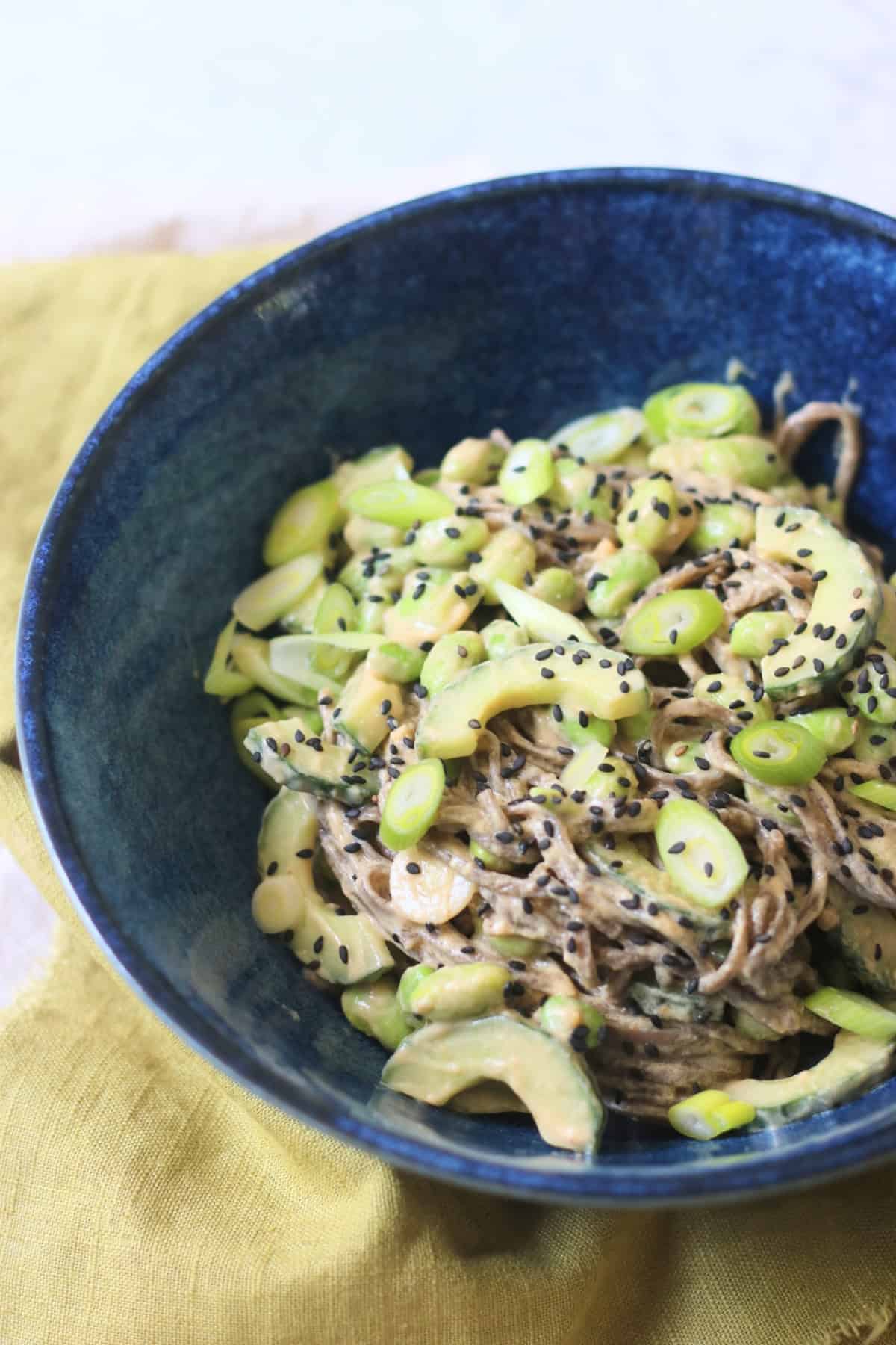 A bowl of Cold Sesame and Peanut Soba Noodles served with a green napkin