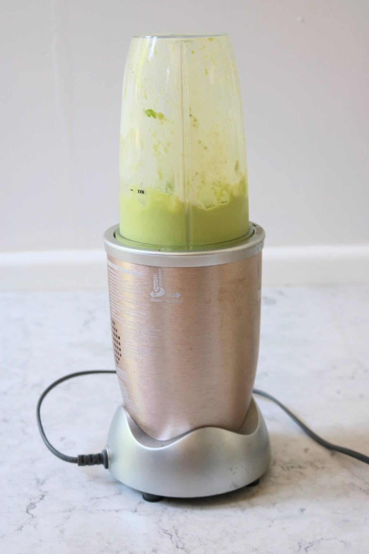 Avocado sauce being blended in a Nutribullet.