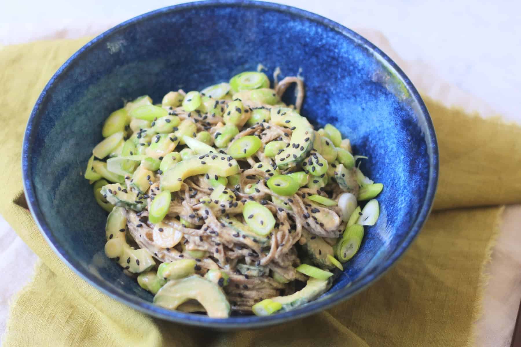 A bowl of Cold Sesame and Peanut Soba Noodles served with a green napkin