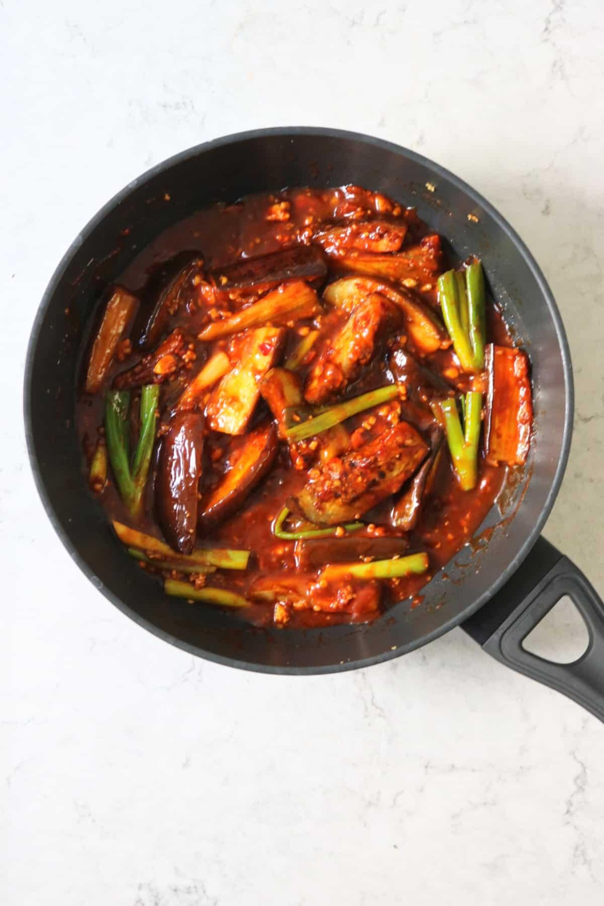 Braising Sichuan Aubergines in a large flat bottomed frying pan