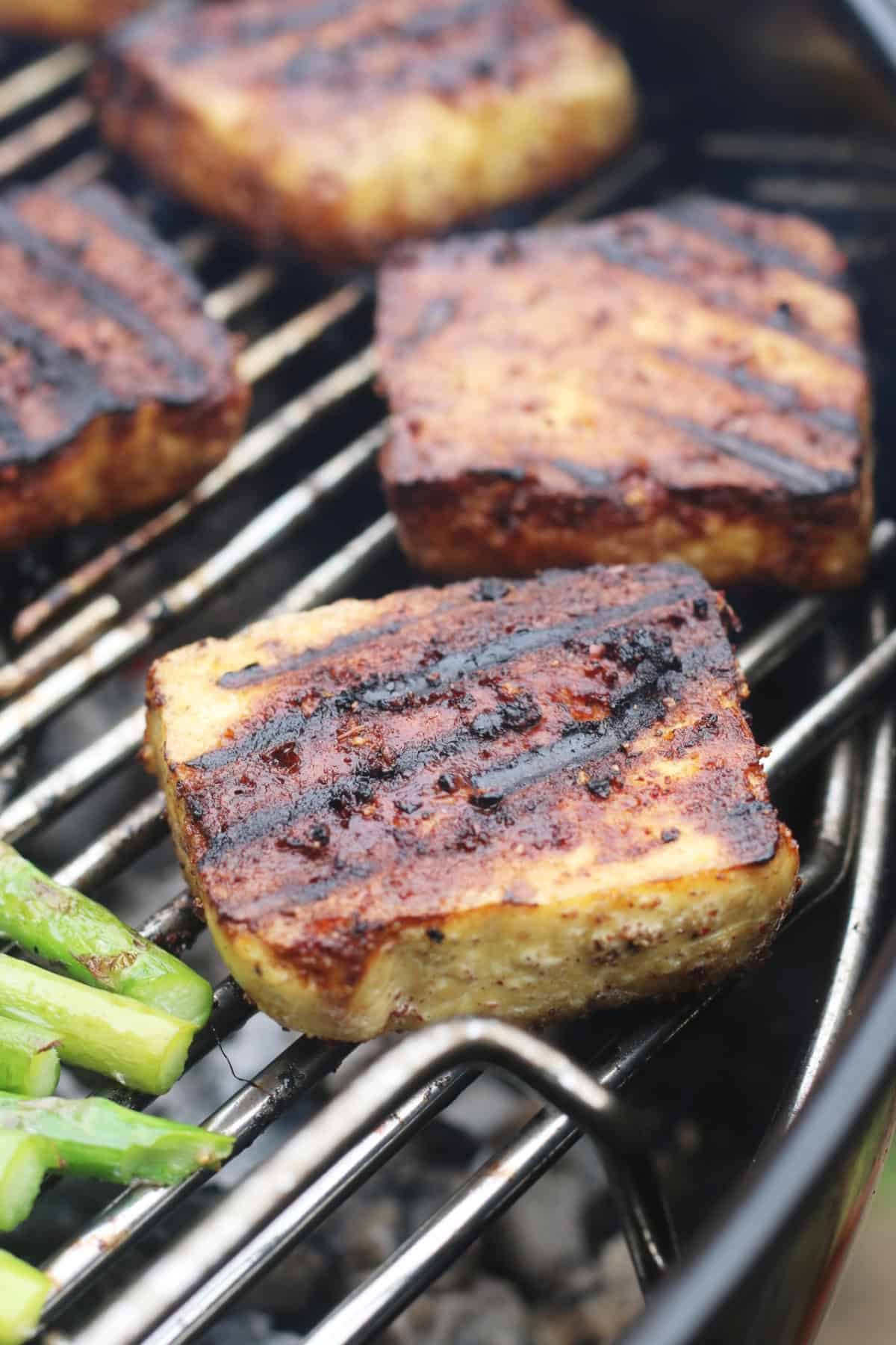BBQ Tofu Steaks grilling on a BBQ.