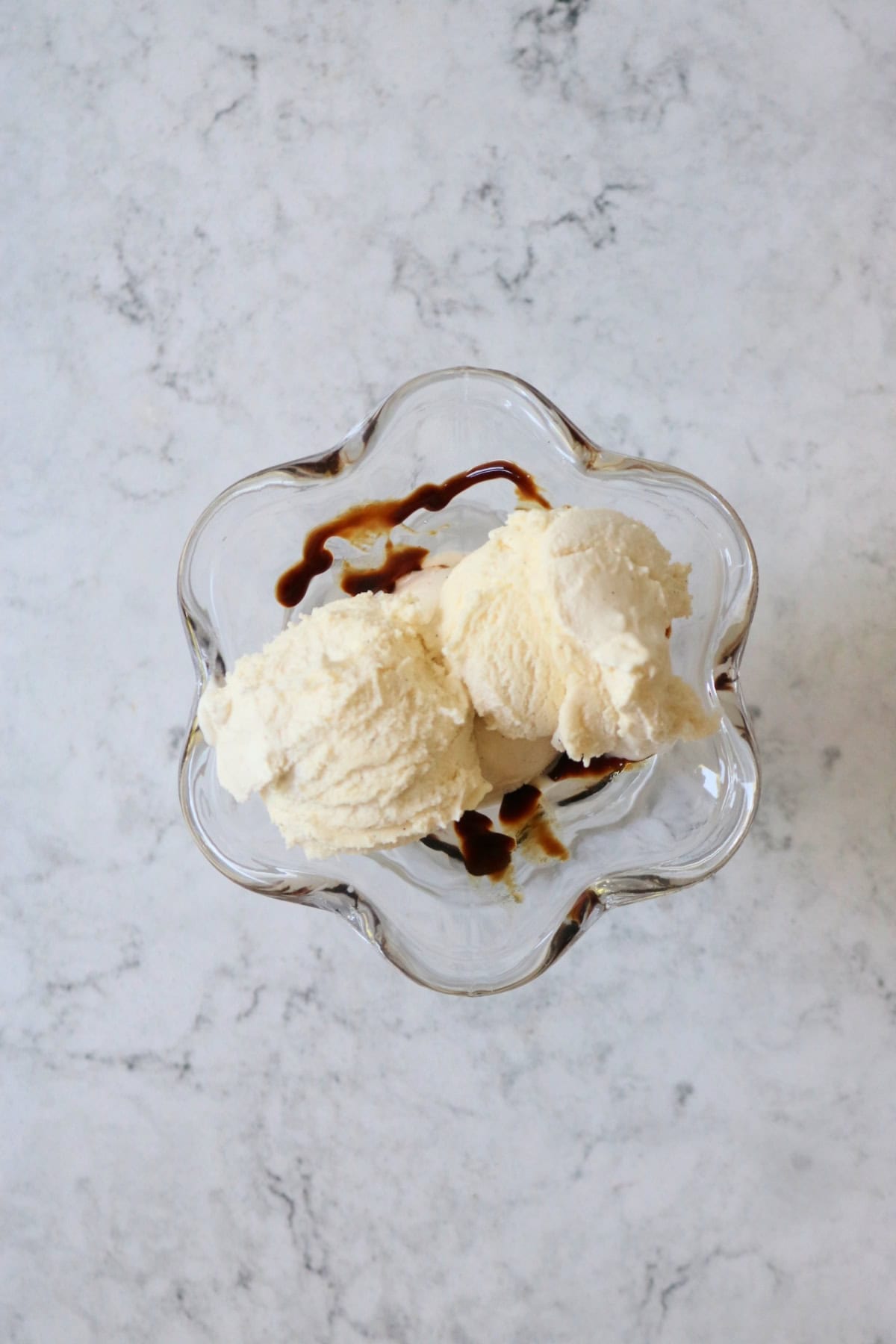 Dairy free ice cream with balsamic glaze in an ice cream sundae glass