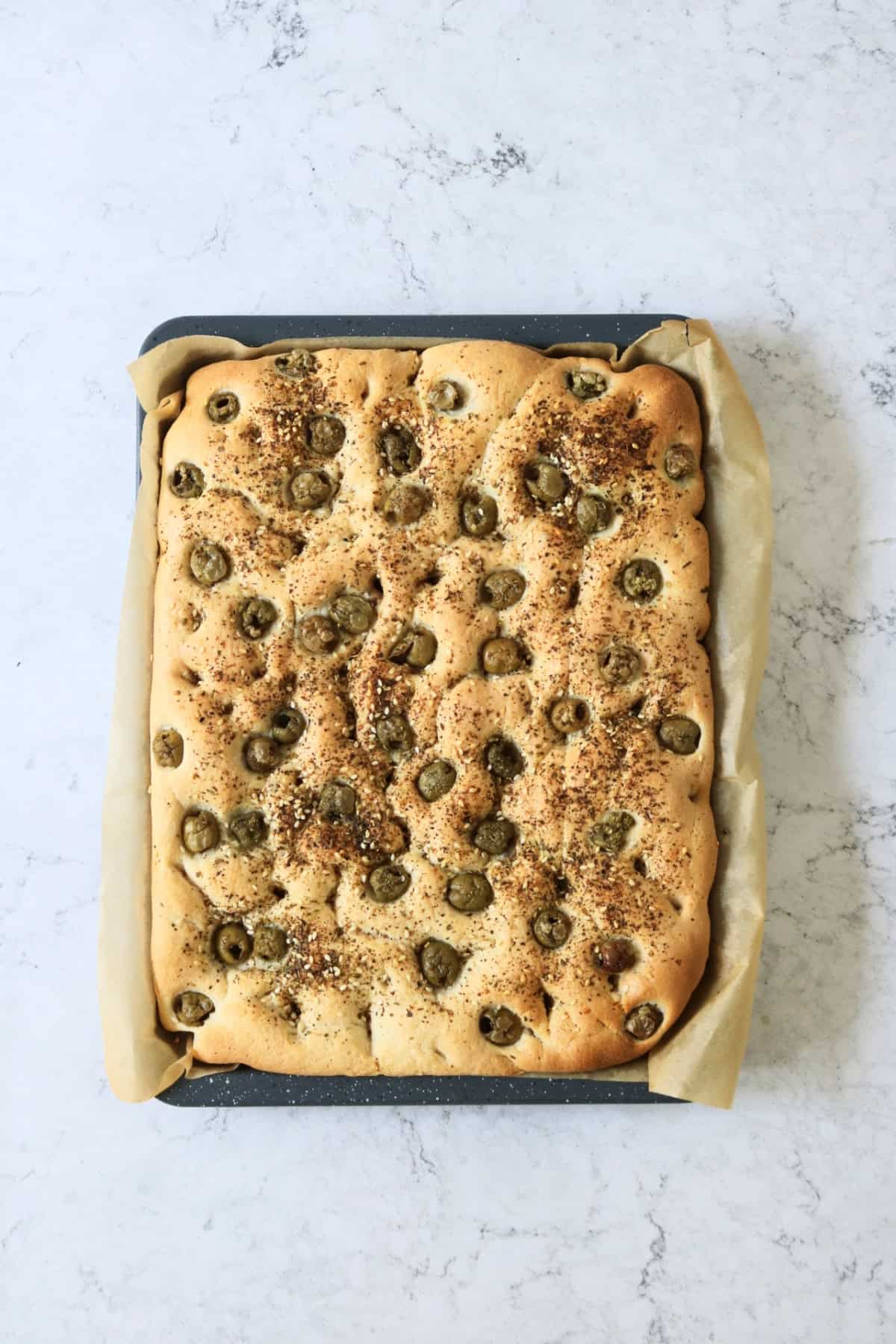 Green Olive and Za'atar Focaccia still on the baking sheet, just out of the oven