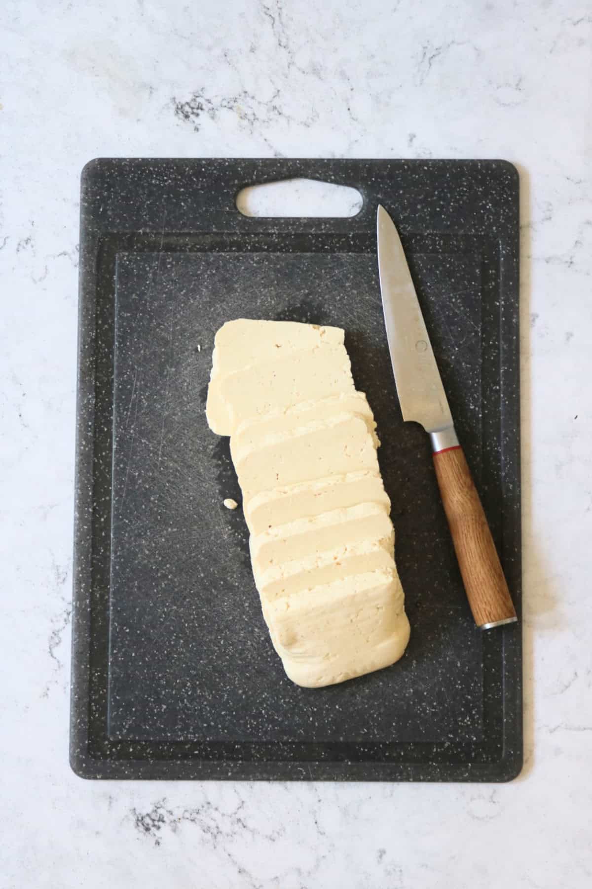 A block of tofu cut into 8 slices.