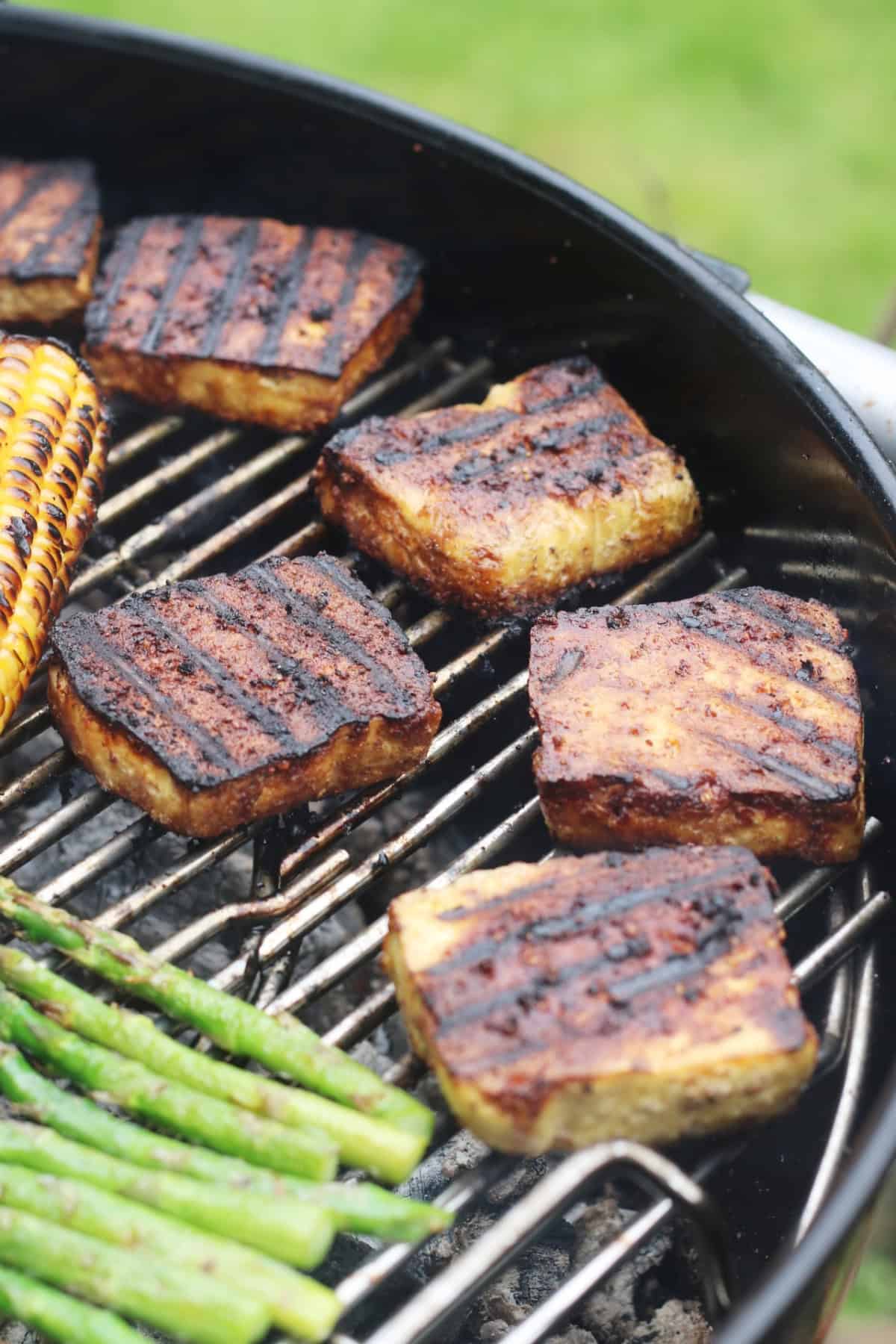 BBQ Tofu Steaks grilling on a BBQ.