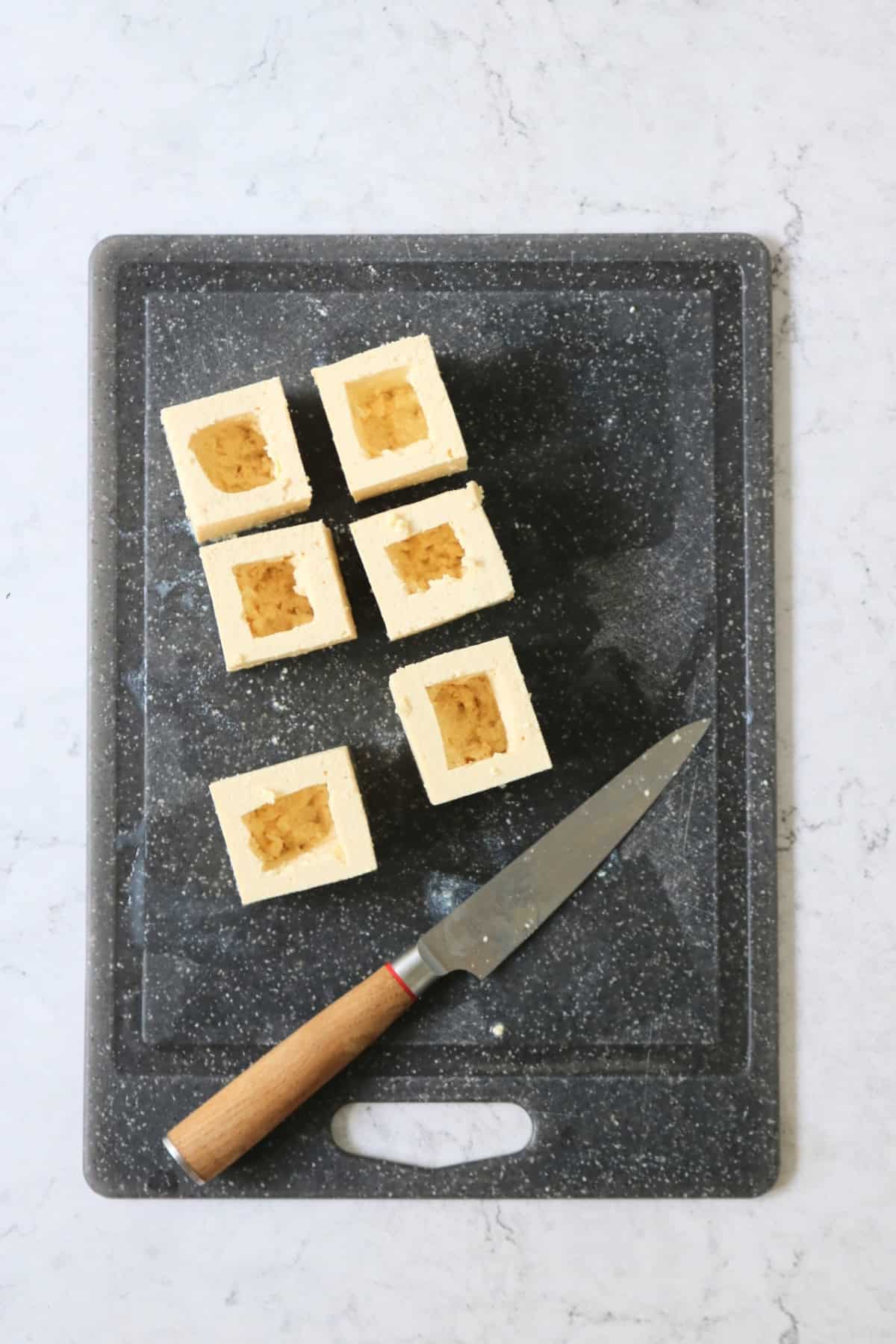 6 squares of tofu with pockets cut into them