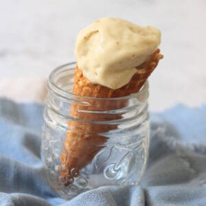 A waffle cone of Vegan Banana and Coconut Ice Cream in a glass jar
