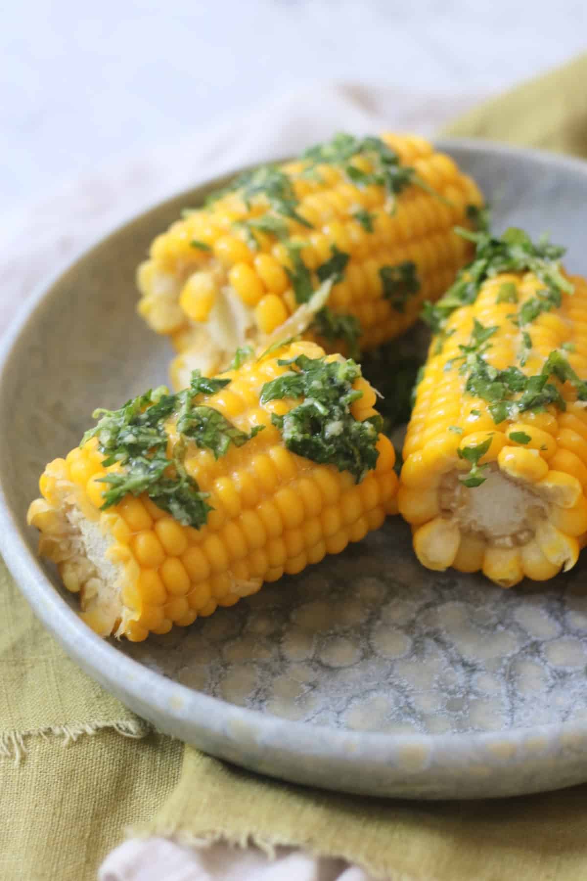 3 corn on the cobs smothered in a herby butter made from vegan butter, coriander, parsley and roasted garlic.