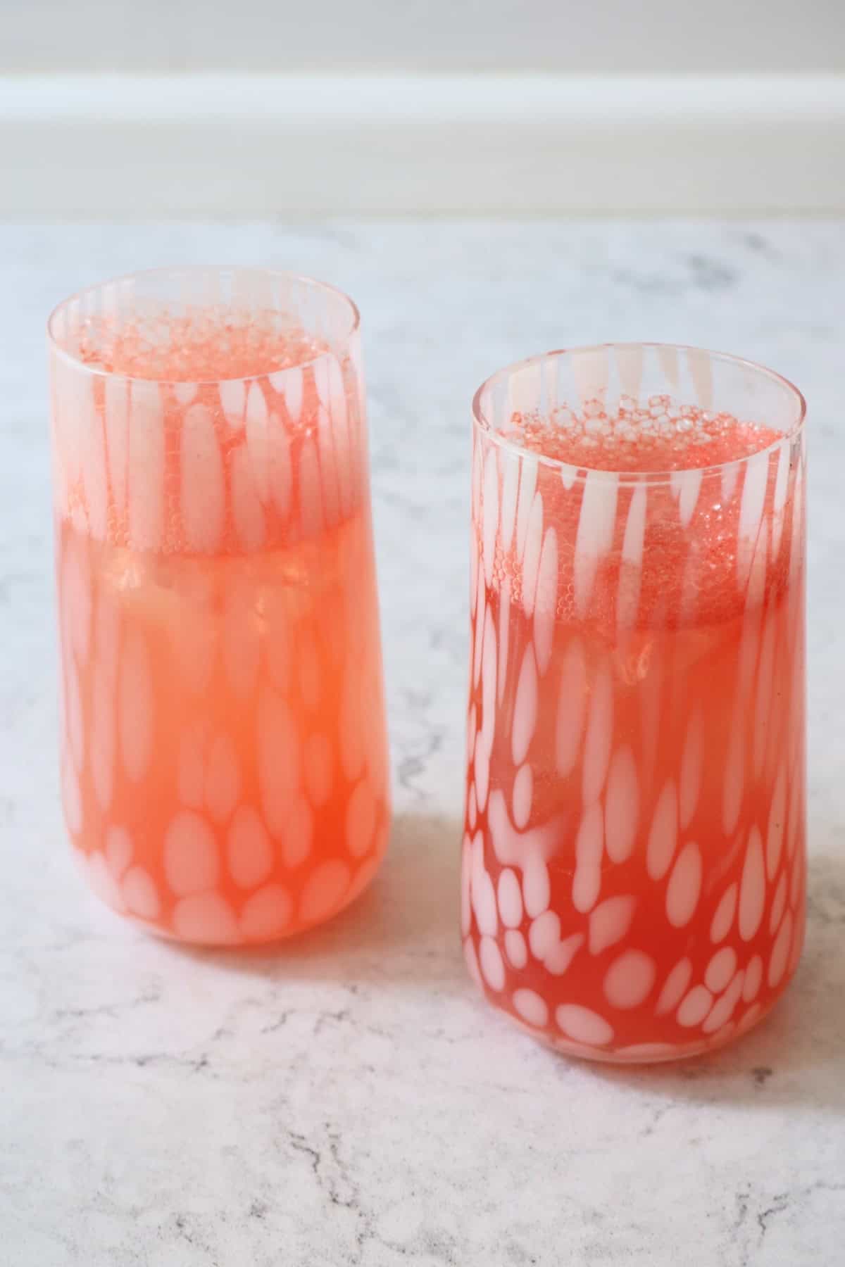 Two tall glasses of Watermelon Agua Fresca topped with soda water