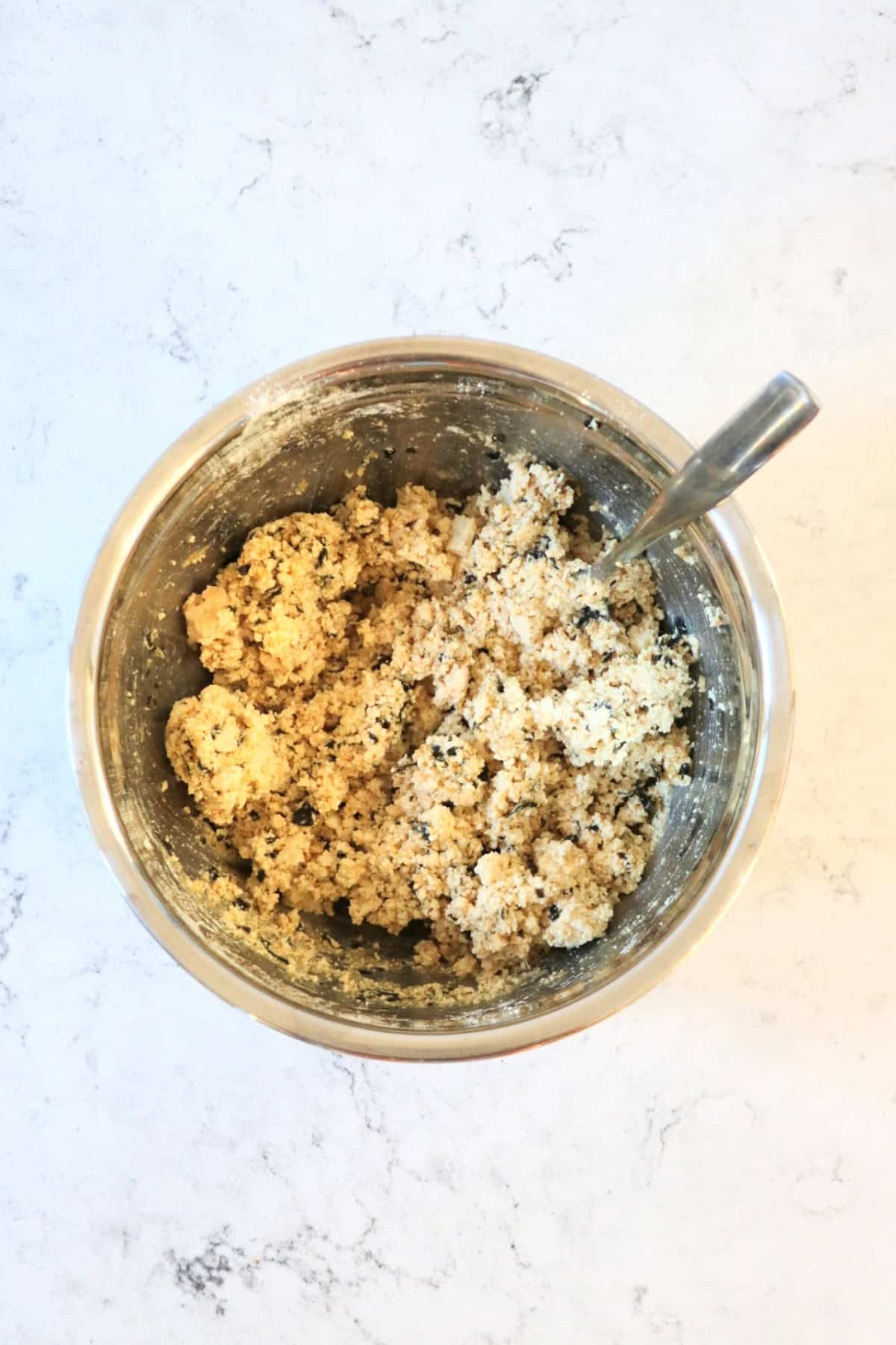 A mixture of crumbled tofu that has been flavoured with nori, nutritonal yeast, garlic powder and onion powder in a bowl, ready to be rolled into vegan fish balls.