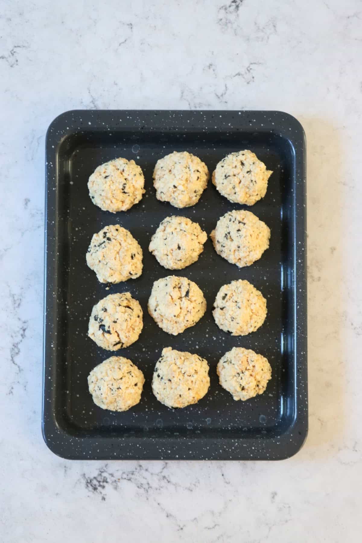 Rolled out Vegan Fish Balls on a baking tray, ready to be fried