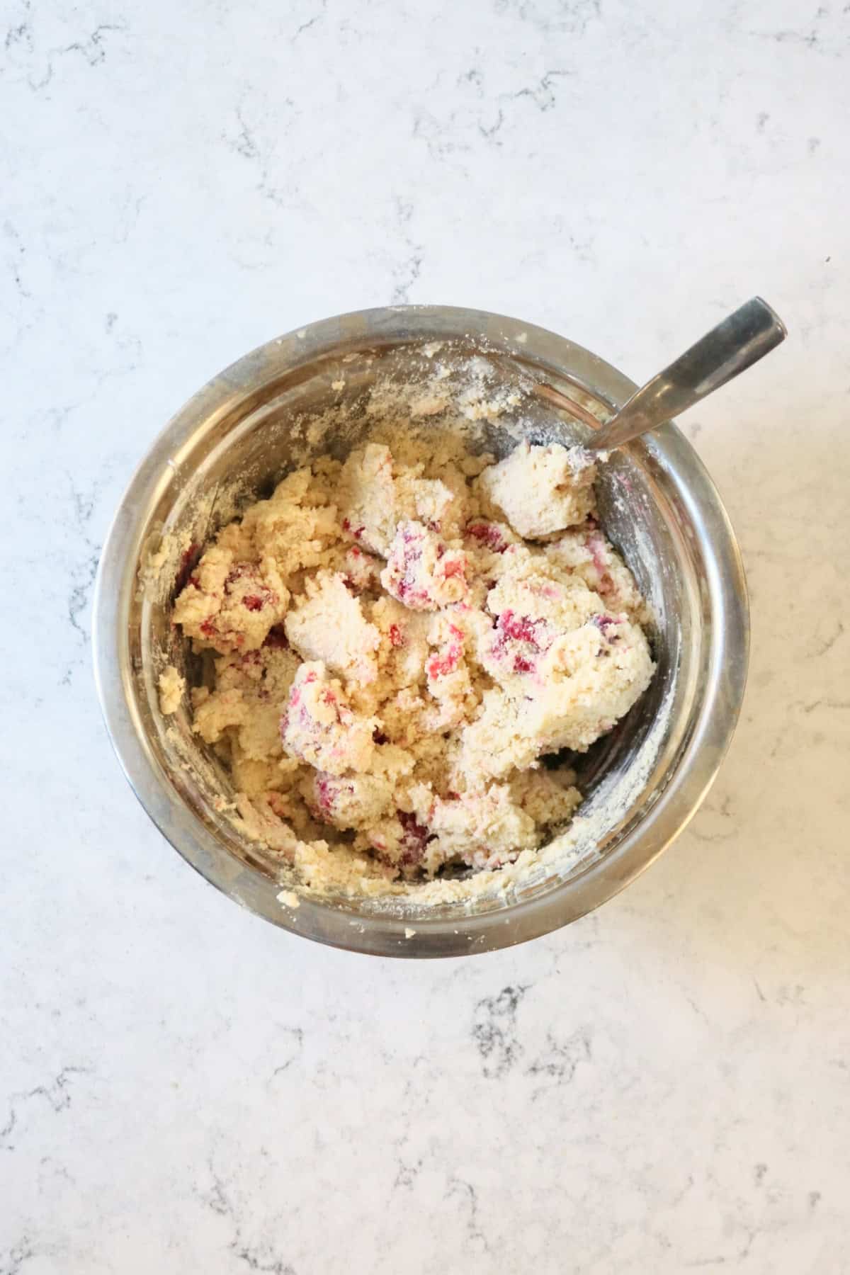 The dough for Vegan Raspberry and Lemon Scones in a metal mixing bowl