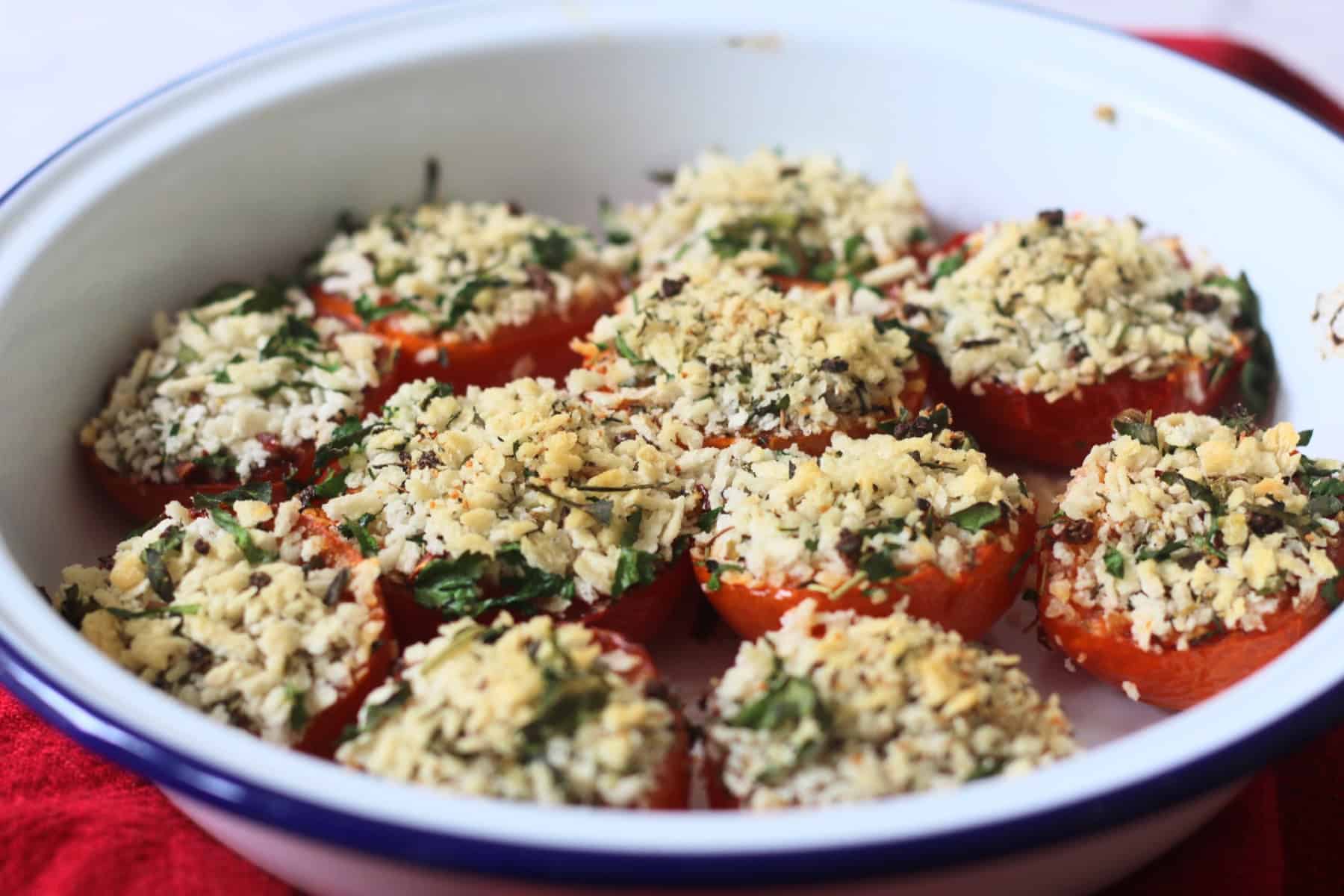 Breadcrumb and herb topped Tomates à la Provençale (Provence Style Tomatoes) in a white and blue enamel dish