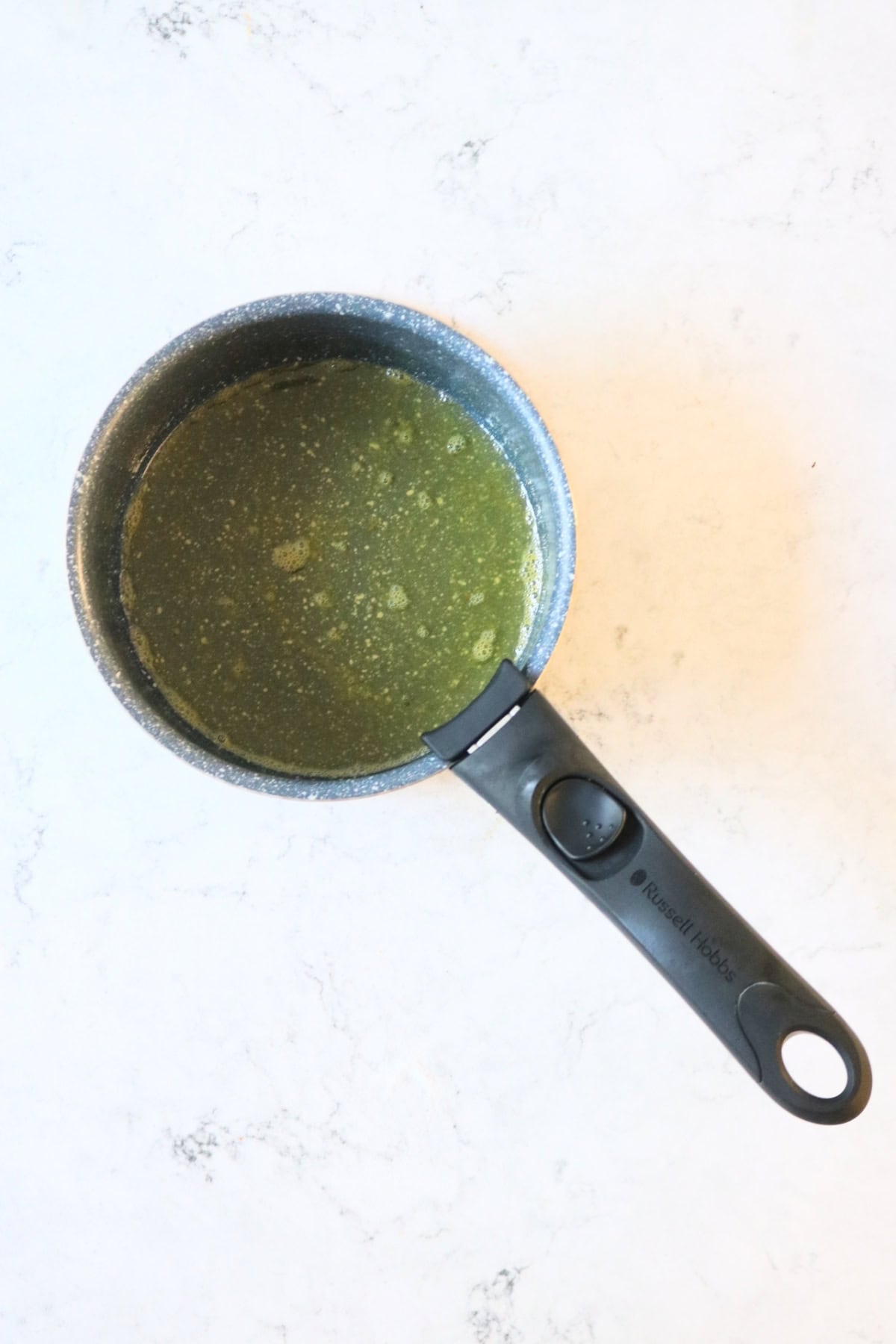 A small saucepan of orange syrup for Vegan Blackberry and Orange Friands