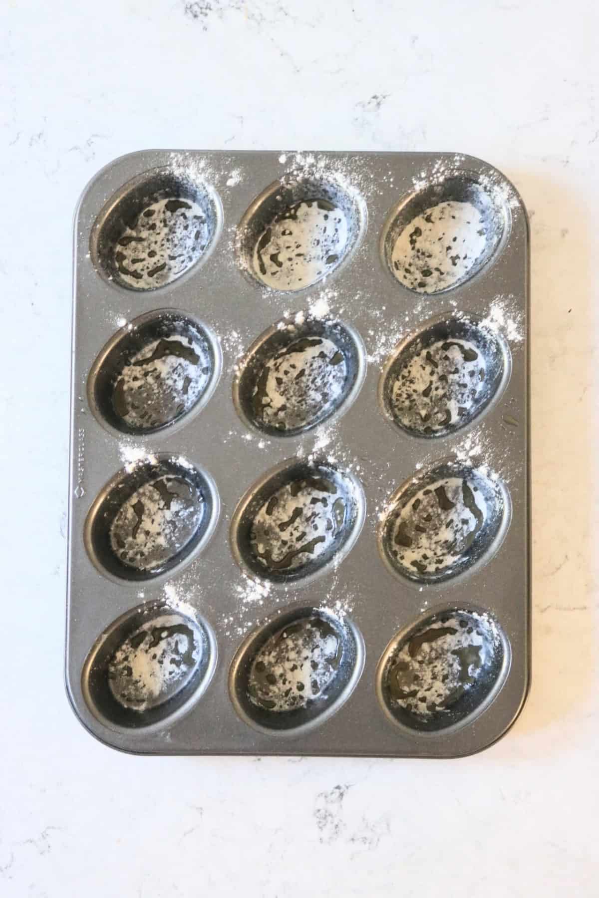 Friand tin dusted with melted butter and flour