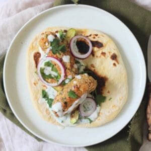 2 Vegan Tofu Kofta with mint yogurt, red onion and baby courgettes served on a flatbread