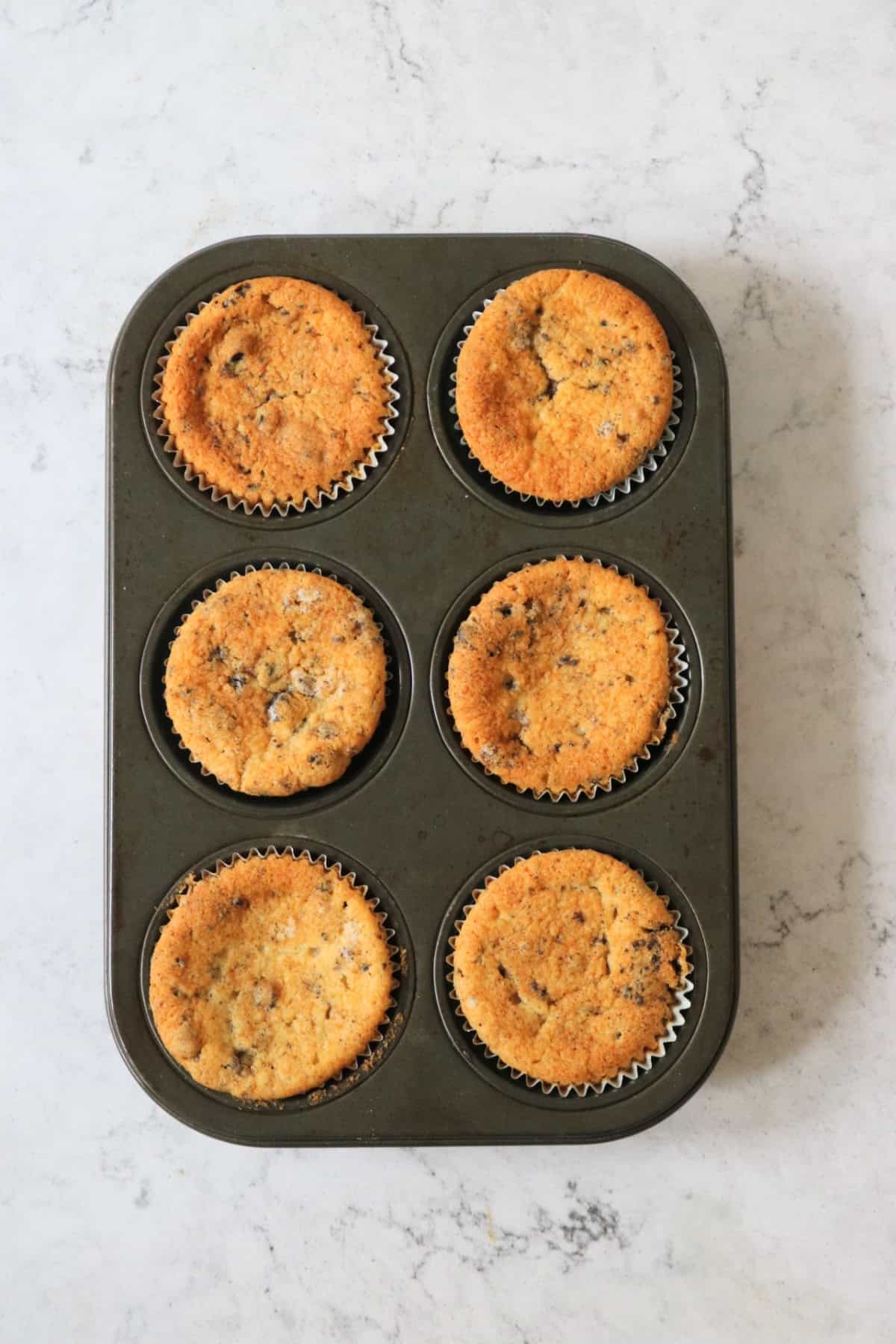 6 Baked Vegan Oreo Cookies and Cream Cupcakes still in the tin