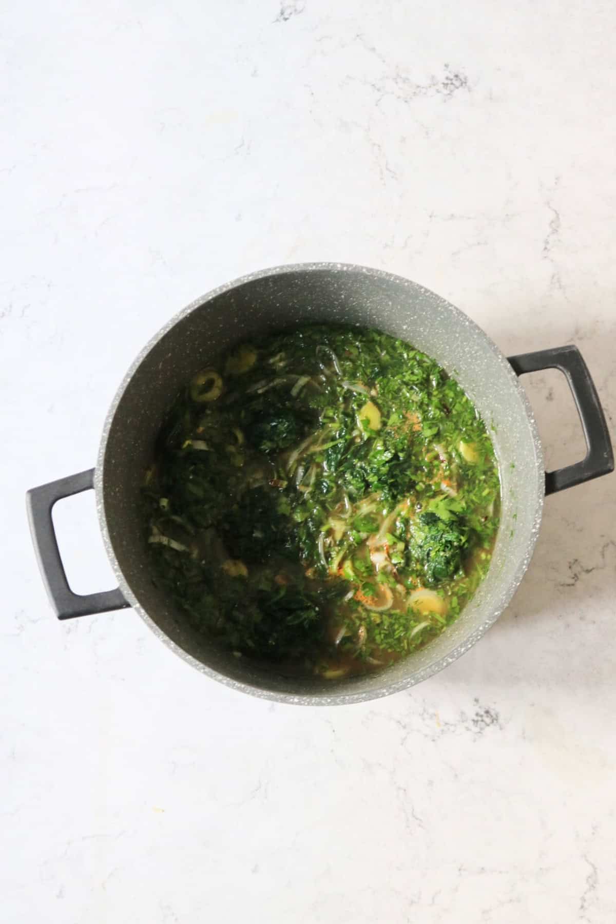 Greek Spinach Rice cooking in a large pan