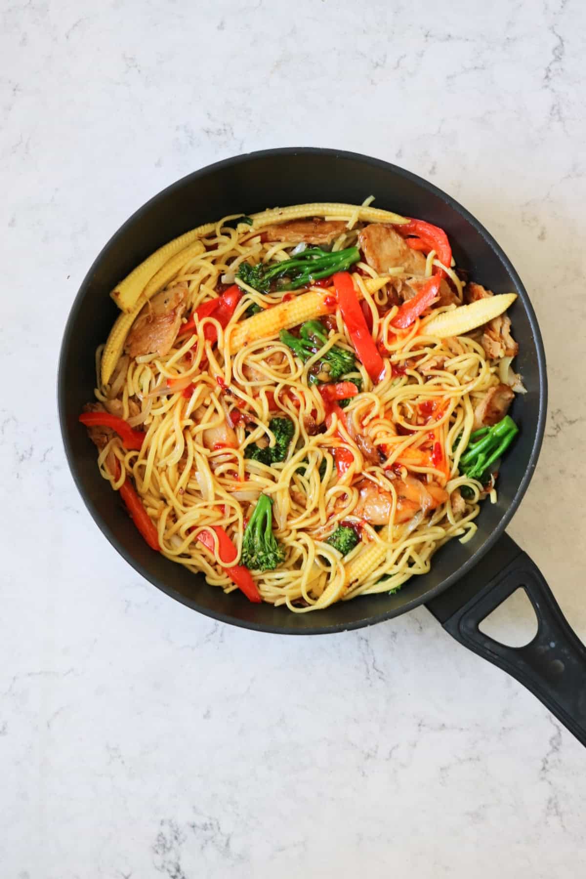 Cooking Vegan Sweet Chilli Chicken Noodles in a large flat bottomed frying pan