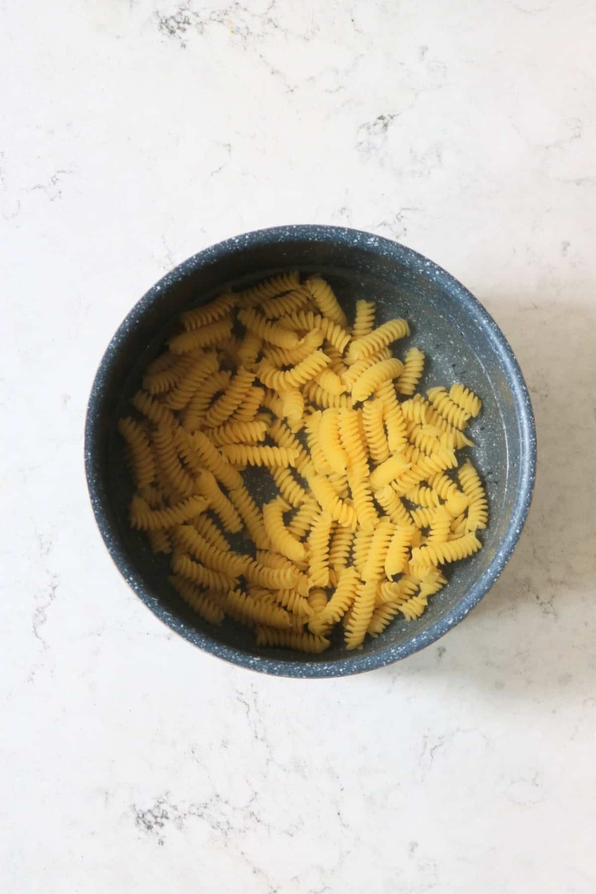 A pan of pasta cooking in boiling water