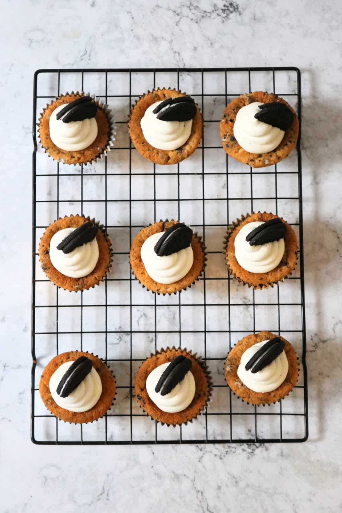 Decorated Vegan Oreo Cookies and Cream Cupcakes on a wire rack