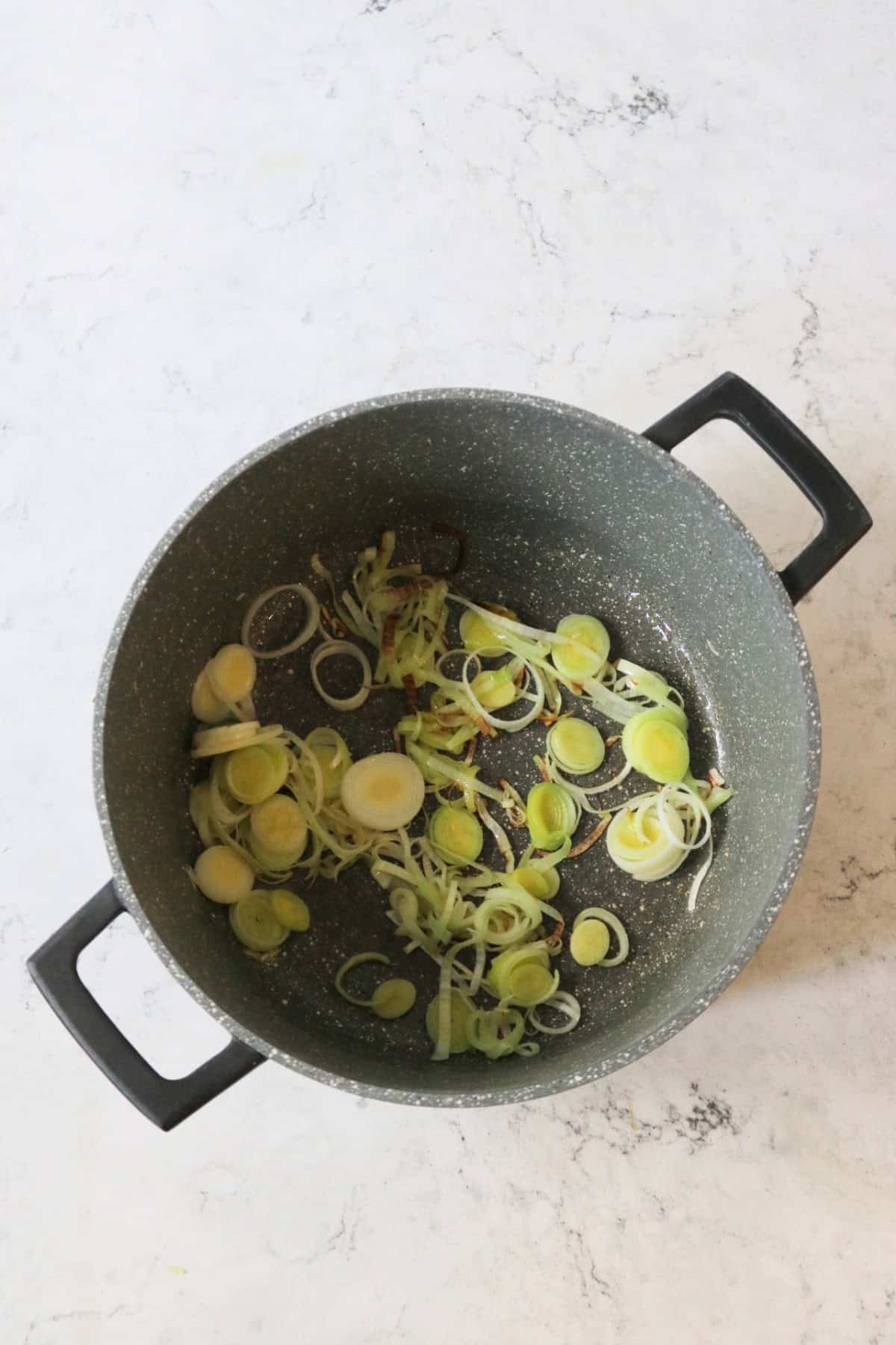 Frying leeks in a large pan