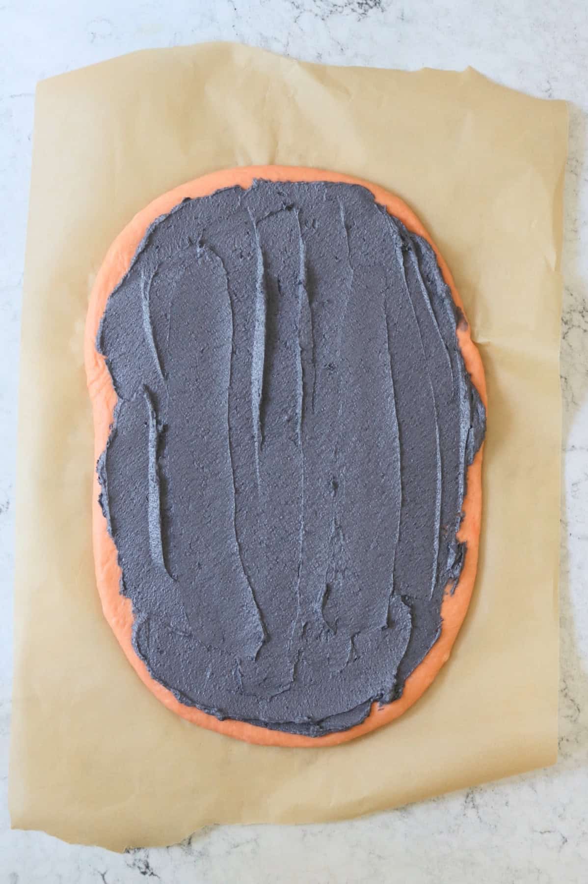 Vegan Halloween Pumpkin Spice Roll filling spread over dough