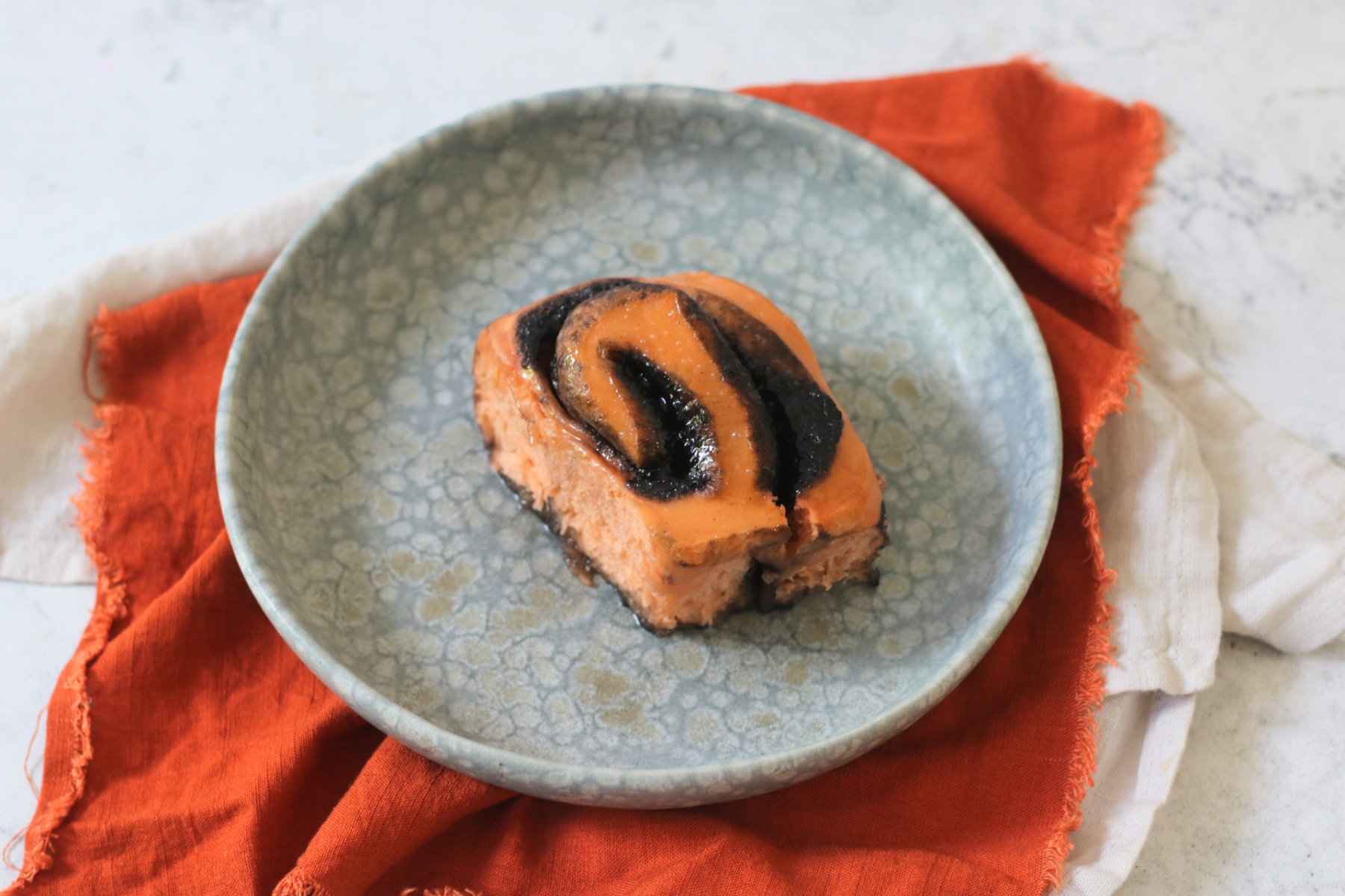 A single Vegan Halloween Pumpkin Spice Roll on a plate.