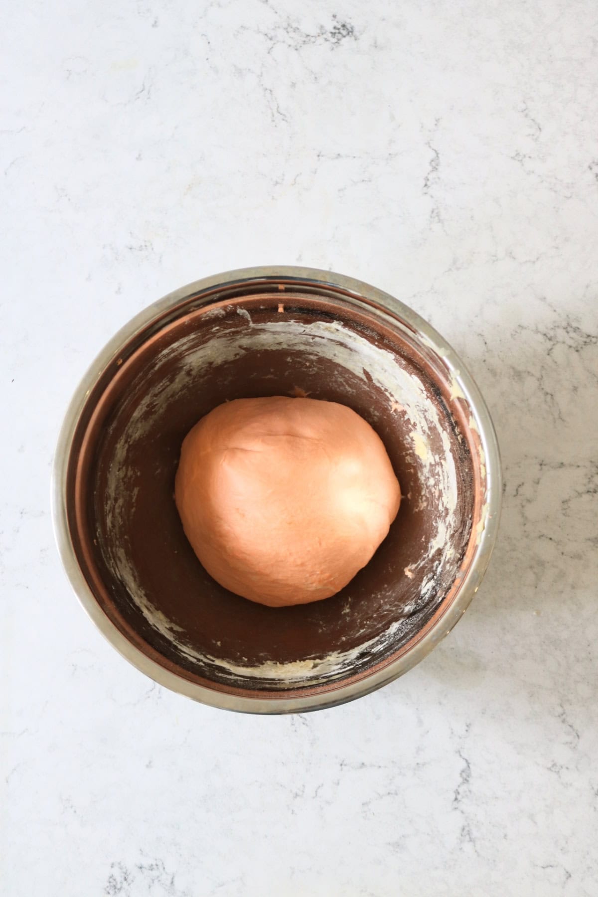 Vegan Halloween Pumpkin Spice Rolls dough ready to prove in a large metal bowl