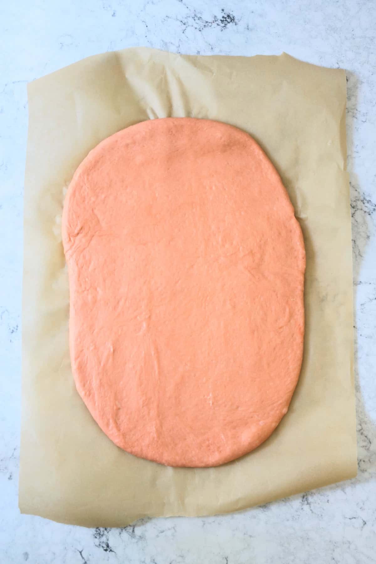 Vegan Halloween Pumpkin Spice Rolls dough rolled out into a rectangle on a piece of baking paper