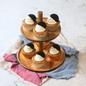 Vegan Oreo Cookies and Cream Cupcakes laid out on a wooden cake stand