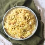 A side dish of Vegan Creamed Cabbage and Leeks served with a dark green napkin