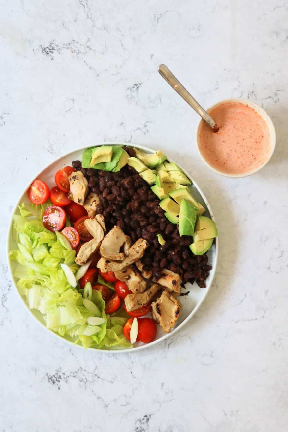 Assembled Vegan Chicken and Avocado Salad with Black Beans with Smoky Dressing on the side