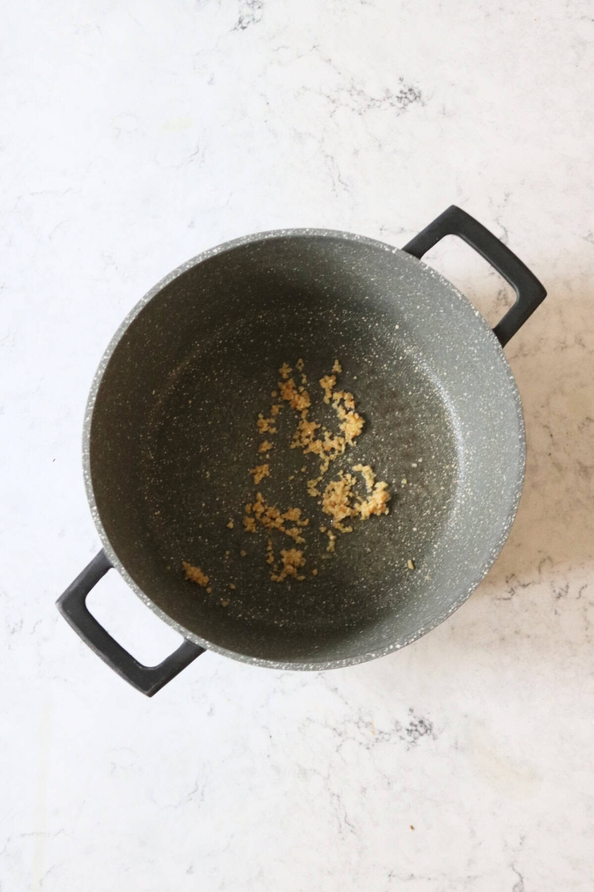 Frying garlic in a large stewing pot