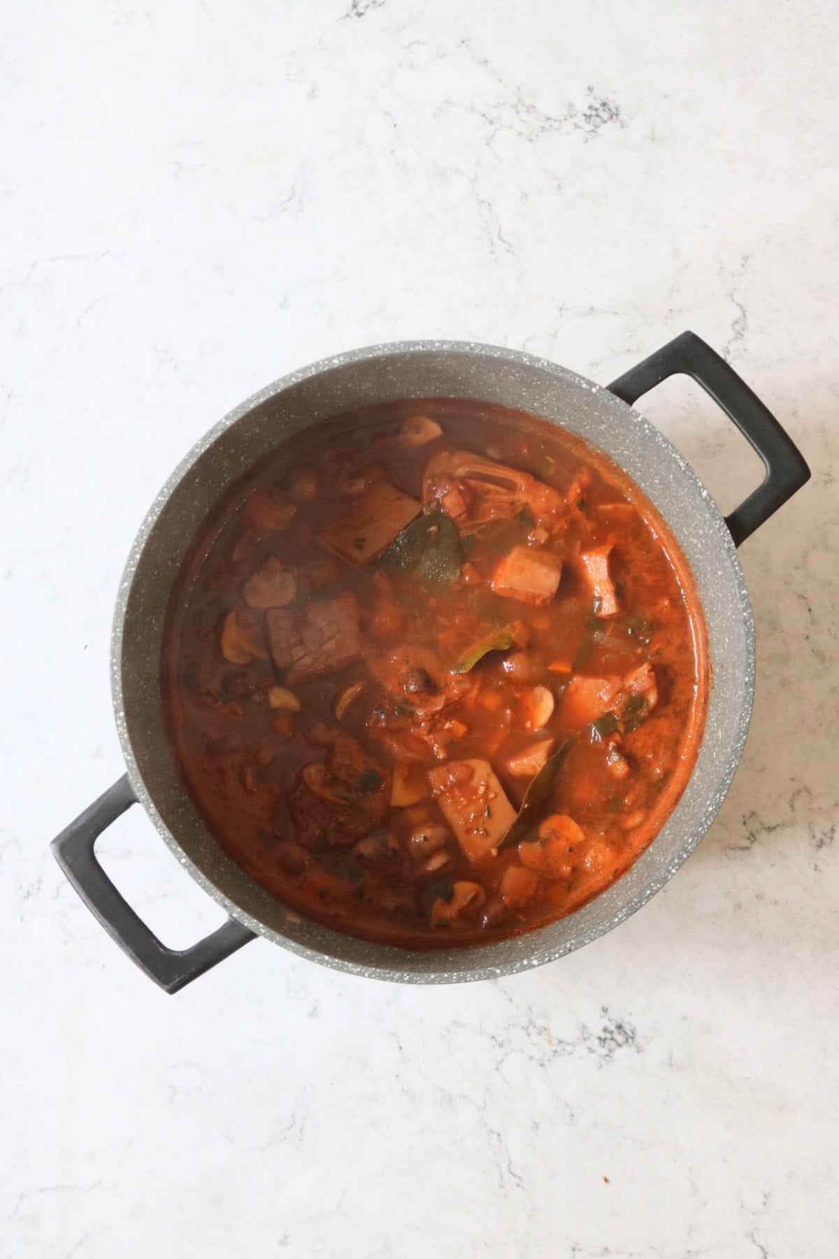 Vegan Coq Au Vin in a large stewing pot that has been simmered to combine all the flavours