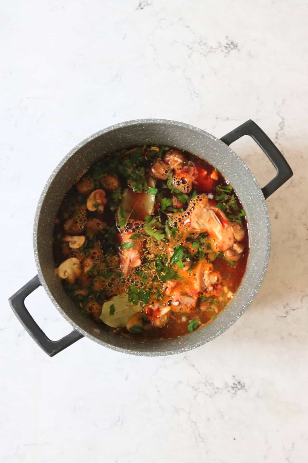 Simmering Vegan Coq Au Vin in a large stewing pot