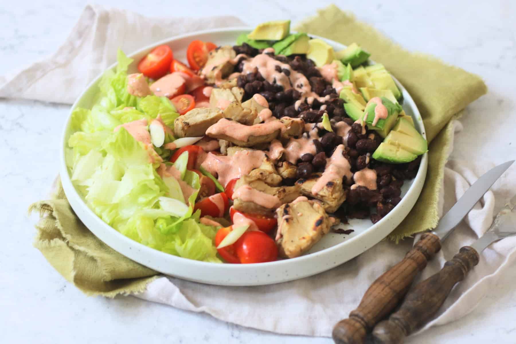 Vegan Chicken and Avocado Salad with Black Beans and a Smoky Paprika Yogurt Dressing drizzled over the top