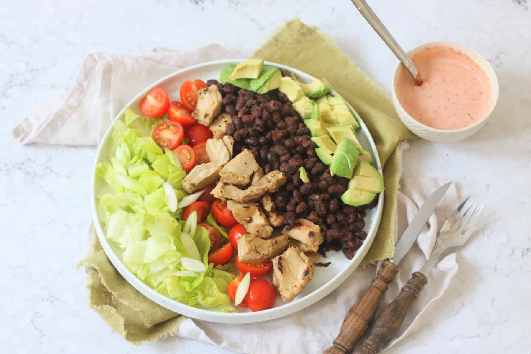 Assembled Vegan Chicken and Avocado Salad with Black Beans with Smoky Dressing on the side