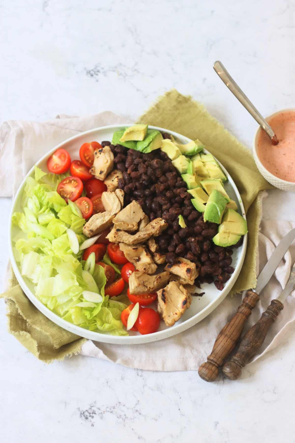 Assembled Vegan Chicken and Avocado Salad with Black Beans with Smoky Dressing on the side
